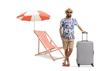 Full length portrait of a bearded man with a suitcase and a beach chair and umbrella