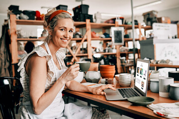 Portrait, ceramic woman and laptop in workshop for research, inspiration and planning for pottery project. Coffee cup, female artist and digital screen for design, inventory management and orders