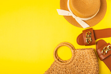 Beach bag, straw hat and sandals on a bright colored background. Beach object. Summer stylish...