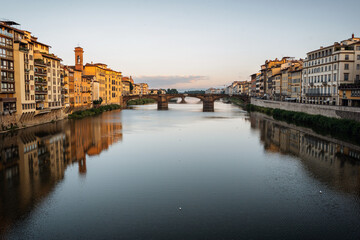 Obraz premium Summer morning in Florence. Ponto Vecchio and the historic center. People go jogging at dawn and there are no tourists.