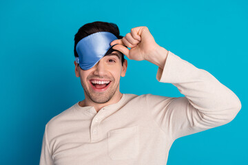 Photo portrait of handsome young guy peek eyes covered mask sleep dressed sleepwear sleepover good...