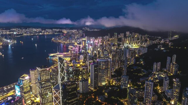 Downtown skyscrapers cityscape at night, drone hyperlapse, Hong Kong, China, 4K