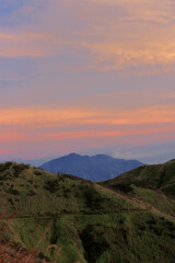 Mount Arjuno Welirang in a distance with colorful sky during sunrise.