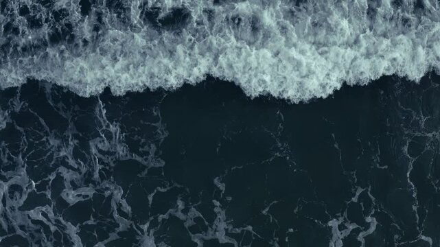 Aerial view of the dark blue ocean with textured water patterns