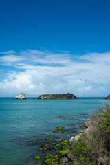 Virgin beach in the Caribbean. Turquoise blue beaches, with cliffs and vegetation