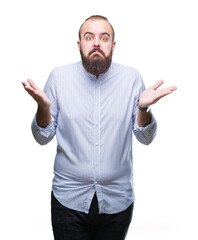 Young caucasian hipster man over isolated background clueless and confused expression with arms and...