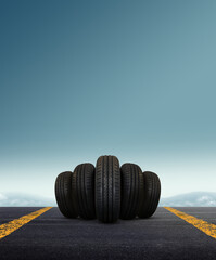 Stack of Tires on an Empty Road with Blue Sky Background © memorystockphoto