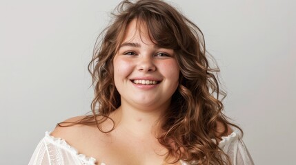 Young overweight woman smiling on a white background