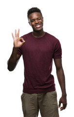 Young african american man doing ok sign with fingers, excellent symbol