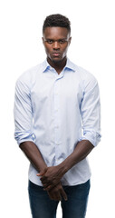 Fototapeta premium Young african american man wearing a shirt with a confident expression on smart face thinking serious