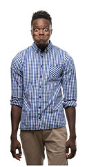 Fototapeta premium Young african american man wearing blue shirt puffing cheeks with funny face. Mouth inflated with air, crazy expression.