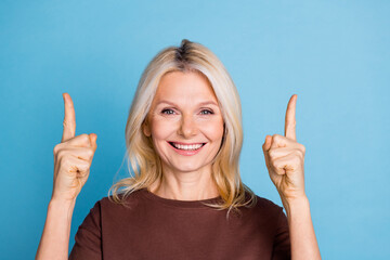 Photo of lovely gorgeous woman wear trendy brown clothes presenting empty space isolated on blue color background