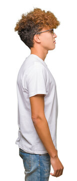 Young handsome man with afro hair wearing sunglasses looking to side, relax profile pose with natural face with confident smile.