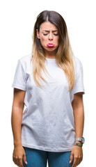 Fototapeta premium Young beautiful woman casual white t-shirt over isolated background depressed and worry for distress, crying angry and afraid. Sad expression.
