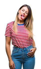 Fototapeta premium Young beautiful woman casual look over isolated background sticking tongue out happy with funny expression. Emotion concept.