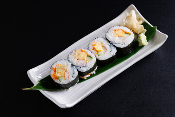 tamago maki roll japanese food isolate in black background