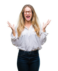 Young beautiful blonde business woman wearing glasses over isolated background celebrating mad and...