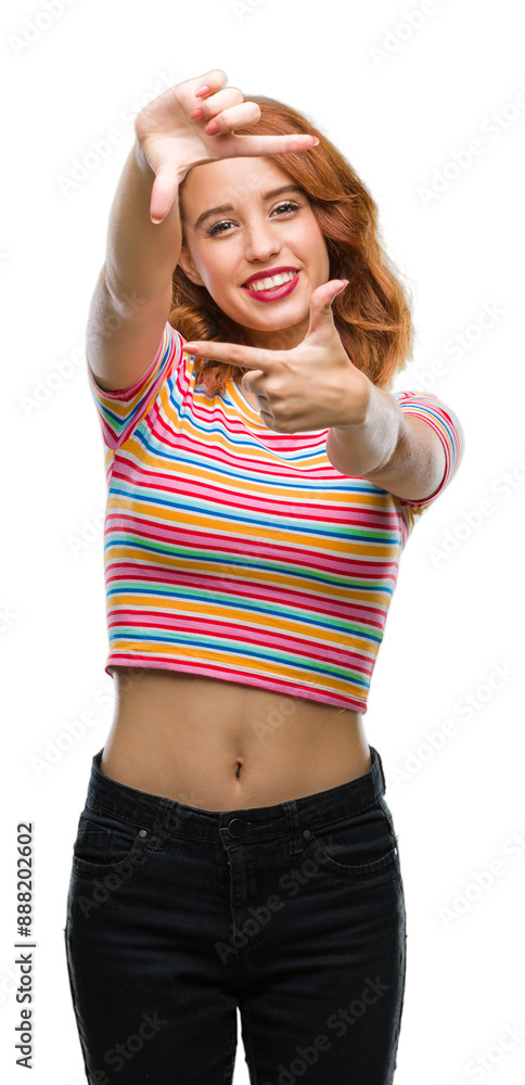 Wall mural young beautiful woman over isolated background smiling making frame with hands and fingers with happ