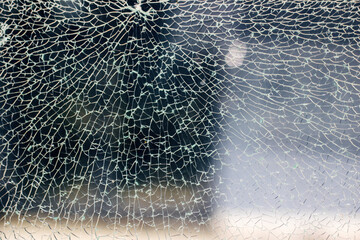 A fractured glass window revealing detailed patterns and textures