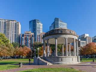 The historic architecture of the Boston Public Garden and Boston Commons with some locals and tourists passing by on an autumn day