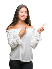 Young beautiful arab woman over isolated background smiling and looking at the camera pointing with two hands and fingers to the side.