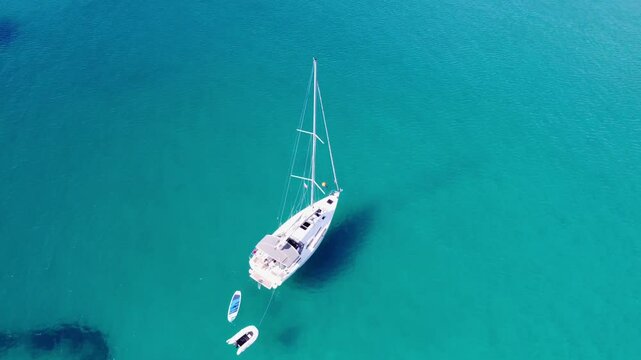 Top drone view of yachts moored on buoys near the shore in the bay of Uvala Gradina near the town of Vela Luka on the island of Korcula in Croatia