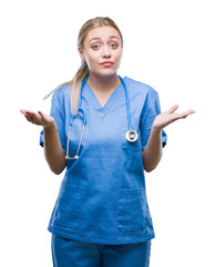 Young blonde surgeon doctor woman over isolated background clueless and confused expression with...