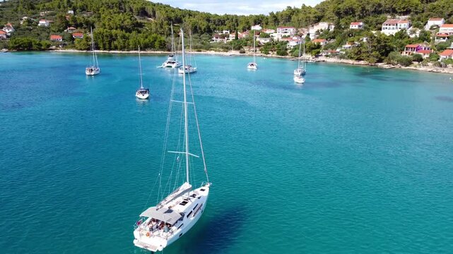 Drone view of yachts moored on buoys near the shore in the bay of Uvala Gradina near the town of Vela Luka on the island of Korcula in Croatia
