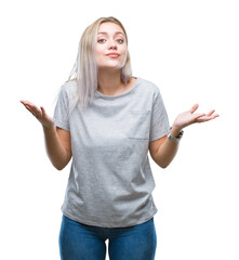 Young blonde woman over isolated background clueless and confused expression with arms and hands...