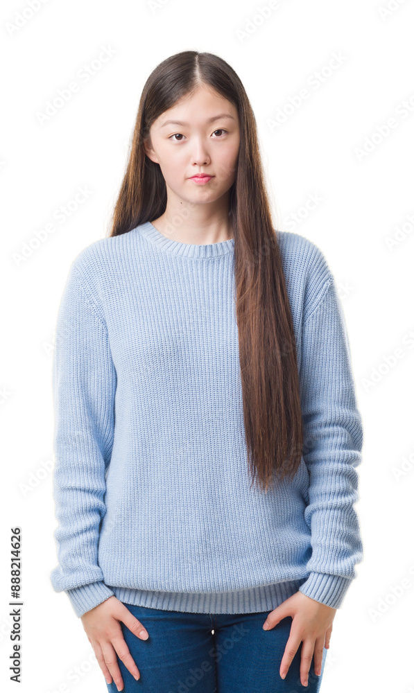 Sticker Young Chinese woman over isolated background with serious expression on face. Simple and natural looking at the camera.