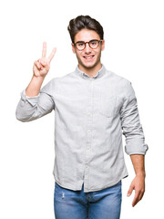Naklejka premium Young handsome man wearing glasses over isolated background showing and pointing up with fingers number two while smiling confident and happy.
