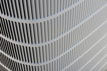 An abstract image of the metal fins and grating on a heat pump coil.