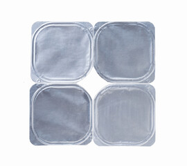 plastic containers of yoghurt with foil lid, isolated on white background. Top view.