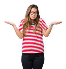 Young beautiful brunette woman wearing glasses and stripes t-shirt over isolated background...