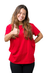 Young beautiful brunette woman wearing red t-shirt over isolated background doing happy thumbs up gesture with hand. Approving expression looking at the camera showing success.