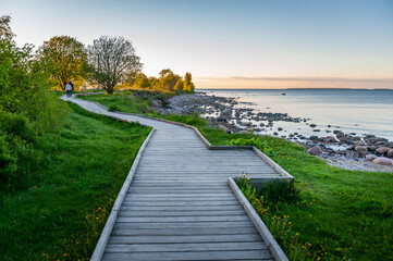 Boardwalk through flood meadows to the seashore. Hiking trail in Paljassaare, Tallinn,  Estonia. Baltic Sea.