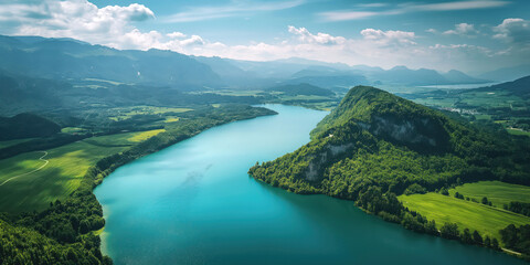 Scenic aerial view of a winding river turning through lush green mountains under a blue sky with clouds, nature landscape concept