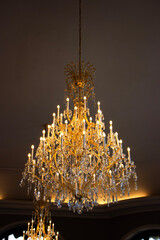 big bright chandelier on, small lights