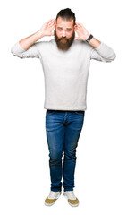 Fototapeta premium Young blond man wearing casual sweater Trying to hear both hands on ear gesture, curious for gossip. Hearing problem, deaf