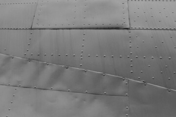 A close-up of the fuselage of an old military airplane.
