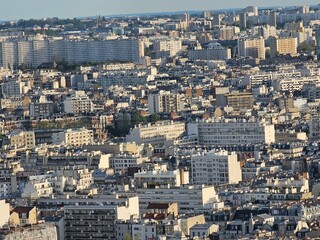 Obraz premium Paris, France - April 12, 2024: Aerial view of Paris skyline with dense urban sprawl and modern skyscrapers, Ile de France, France. Amazing mix between modern skyscraoers and old buildings.