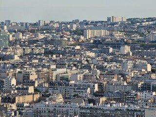 Paris, France - April 12, 2024: Aerial view of Paris skyline with dense urban sprawl and modern skyscrapers, Ile de France, France.  Amazing mix between modern skyscraoers and old buildings.