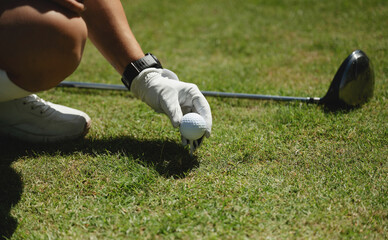 Golfer prepares to tee off on sunny day