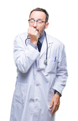 Middle age senior hoary doctor man wearing medical uniform isolated background looking stressed and nervous with hands on mouth biting nails. Anxiety problem.