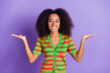 Photo of charming positive woman wear striped shirt comparing arms empty space isolated violet color background