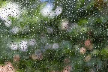 Texture of wet window glass with drops and bokeh