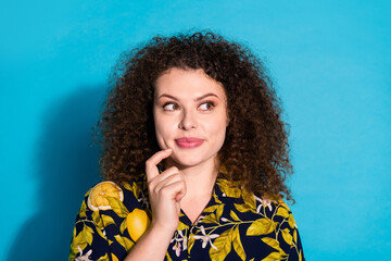 Photo of charming tricky woman wear print shirt finger chin looking empty space isolated blue color...