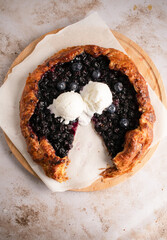 Homemade crispy blueberry galette, on a wooden board
