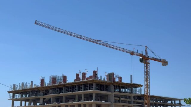 A construction crane performs construction work 