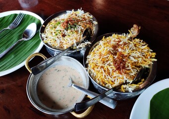 Indian cuisine - Kolkata biryani made with basmati rice with a chicken run, boiled egg and a whole potato.